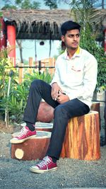 Portrait of young man sitting outdoors