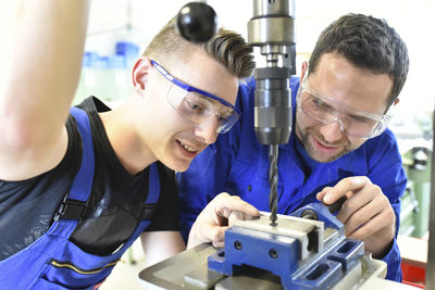 Instructor with trainee at drill machine