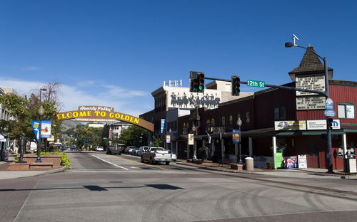 View of city street against blue sky