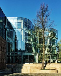 Low angle view of buildings against clear blue sky