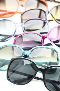 High angle view of various sunglasses on white background