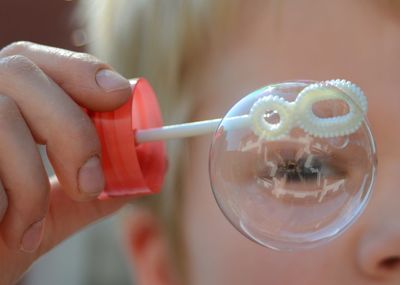 Close-up of boy holding bubble wand