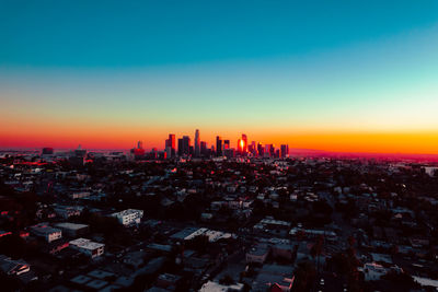 Aerial view of cityscape against sky during sunset