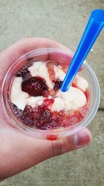 Close-up of hand holding ice cream