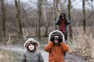 Family standing on road during winter