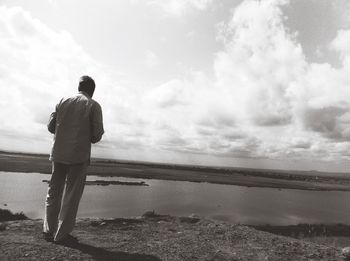 Rear view of man standing on beach