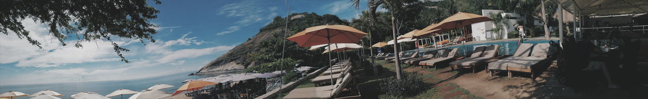 Panoramic view of parasols and lounge chairs at beach