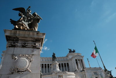 Low angle view of statue against building