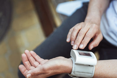 Cropped hand of man using mobile phone