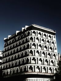 Low angle view of office building against blue sky