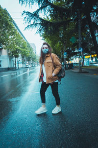 Full length of man standing on street in city