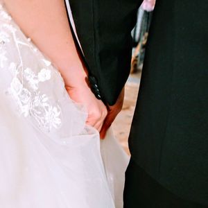 Midsection of couple holding hands