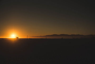 Scenic view of sea against orange sky