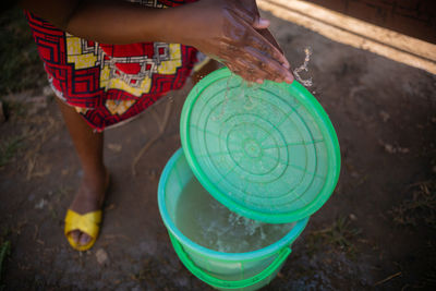 African woman washing her hands, covid-19 measures, corona virus conditions 