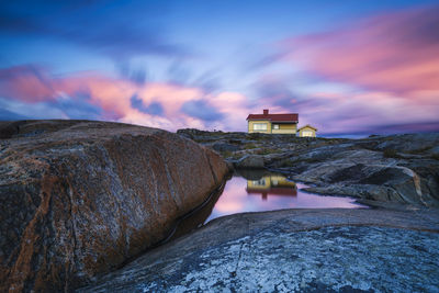 House on rocky coast at twilight