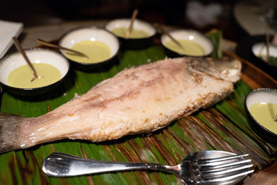 High angle view of fish and leaves on table