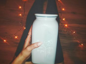Close-up of hand holding glass bottle