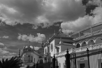 Low angle view of buildings against cloudy sky