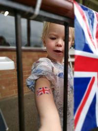 Close-up of girl with british flag on arm
