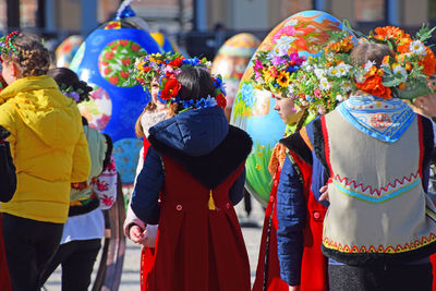 Low section of people on multi colored umbrellas