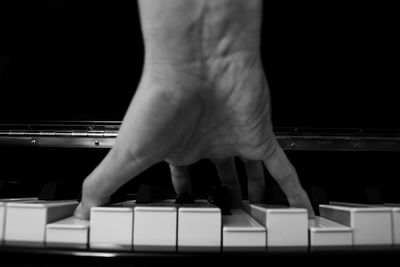 Close-up of man playing piano