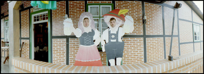 Close-up of a man with woman standing against the wall