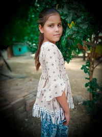 Portrait of smiling girl standing outdoors