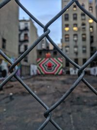 Close-up of chainlink fence against road