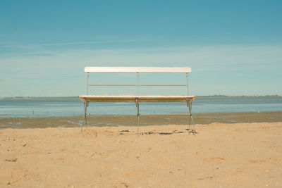 Lifeguard hut on beach against sky