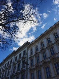 Low angle view of building against cloudy sky