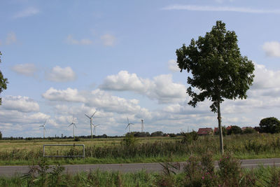 Traditional windmill on field against sky