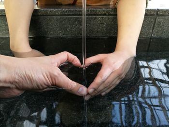 Low section of man holding water