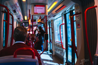 Rear view of man traveling in train