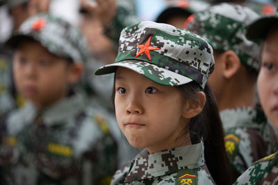 Close-up portrait of cute girl looking away outdoors