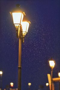 Low angle view of lamp post at night