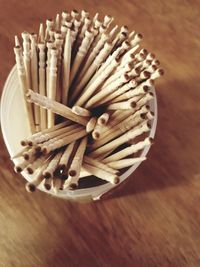 High angle view of toothpicks in container on table