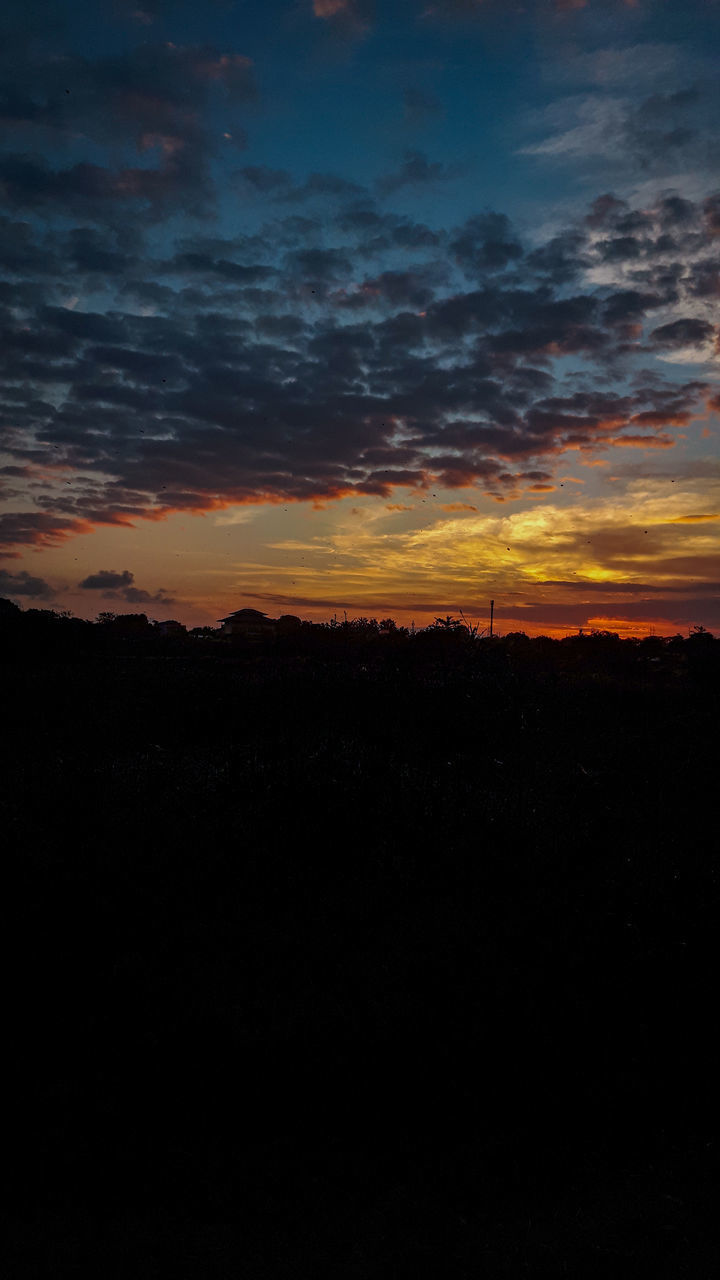 SCENIC VIEW OF SILHOUETTE LANDSCAPE AGAINST DRAMATIC SKY