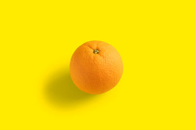 Close-up of apple against orange background