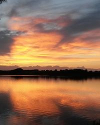 Scenic view of lake against romantic sky at sunset