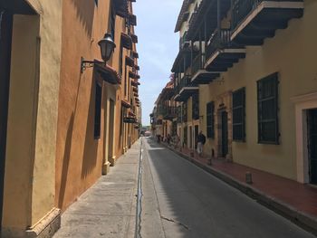 Narrow street amidst buildings