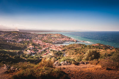 High angle view of townscape by sea against sky