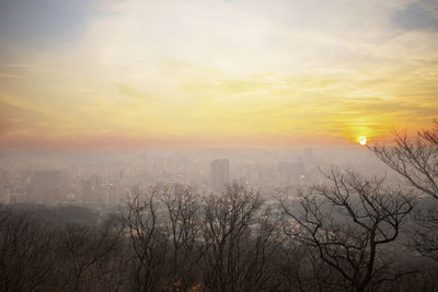 Scenic view of buildings against sky during sunset