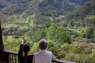 Senior mother and adult daughter traveling at the  view point over the cocora valley at salento