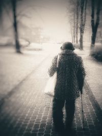 Woman standing on tree trunk