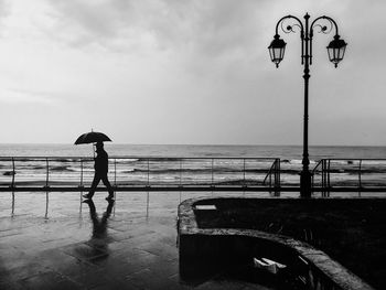 Man standing on beach against sky