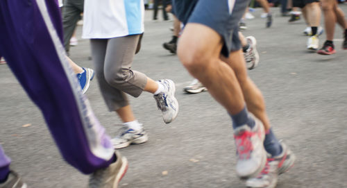 Low section of people running on road