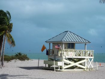 Lifeguard hut on beach against sky