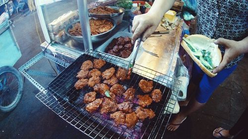 Low section of people on barbecue grill