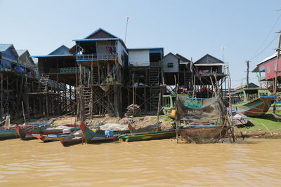 View of fishing boats moored in lake against sky