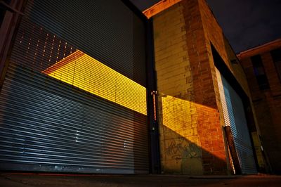 Low angle view of illuminated building against sky